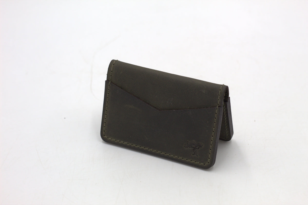 A black leather wallet with a front flap and metal accents, isolated on a white background.