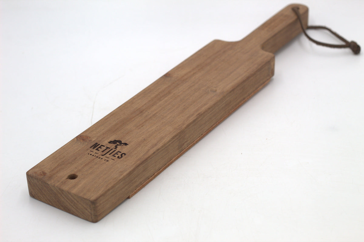 A wooden shaving horse with a leather strap, featuring the Netjies brand logo.
